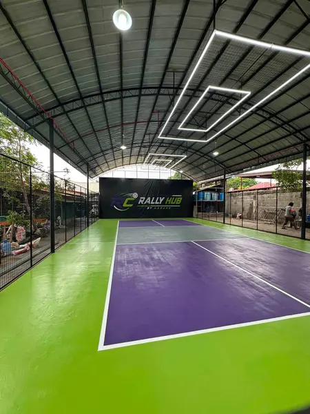 Wide-angle view of the covered RC Rally Hub pickleball court with purple and grey court markings